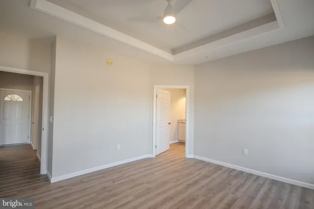 a view of an empty room with wooden floor