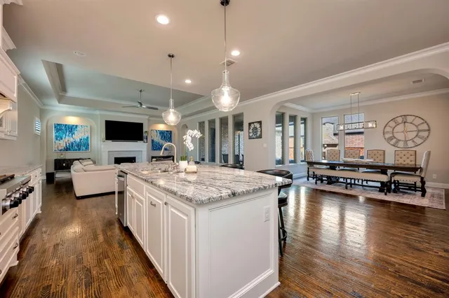 a kitchen with sink stove and cabinets