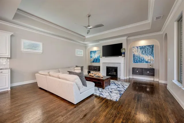 a living room with furniture a fireplace and a flat screen tv