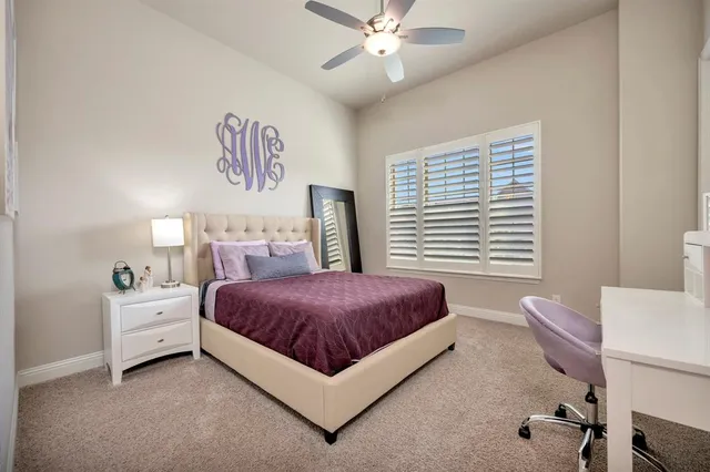 a spacious bedroom with a bed and a chandelier