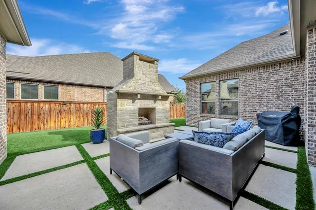a outdoor space with patio the couches and a fireplace with the garden view