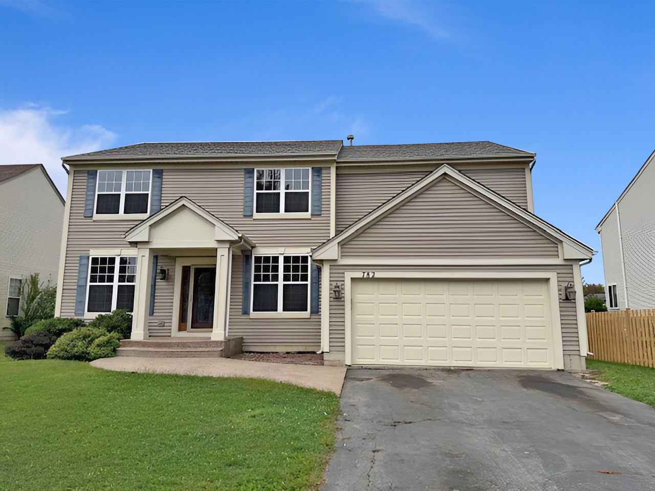 front view of a house with a yard