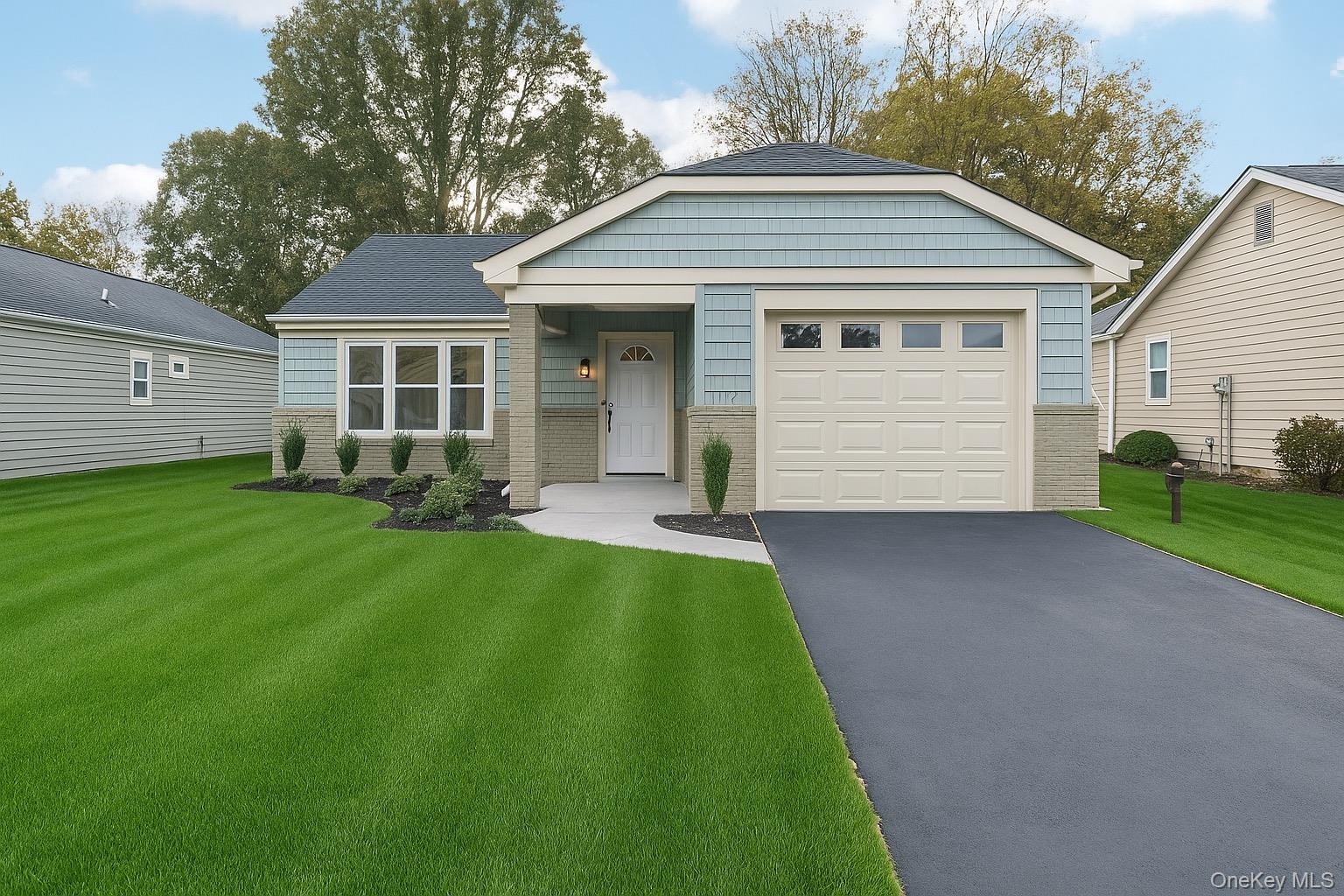 407 Belfast Lane Ridge, NY 11961 - Photo 1 of 1 a front view of a house with a garden and yard