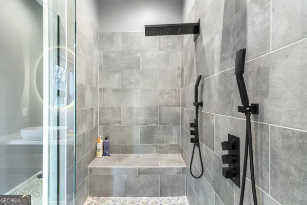 a spacious bathroom with a double vanity sink mirror and shower