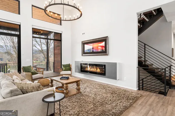 a living room with furniture and large windows