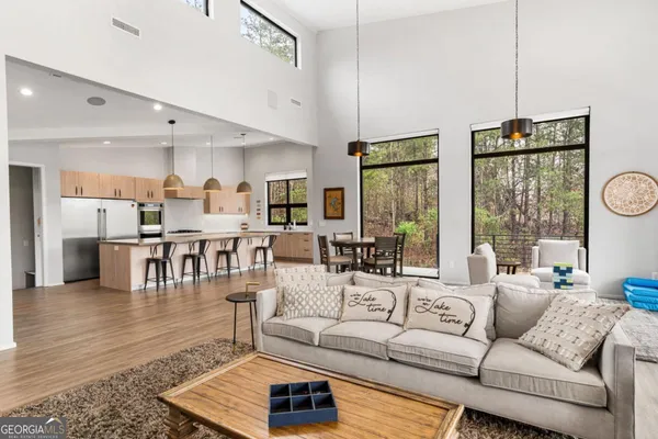 a very nice looking living room with a large window and flat screen tv