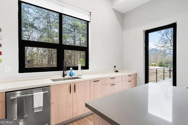 a kitchen with cabinets appliances and a counter space