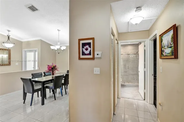 a view of a dining room with furniture and a chandelier fan