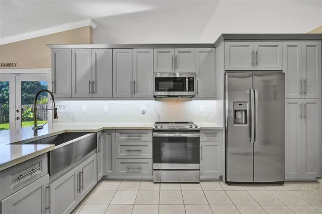 a kitchen with granite countertop a cabinets and steel stainless steel appliances