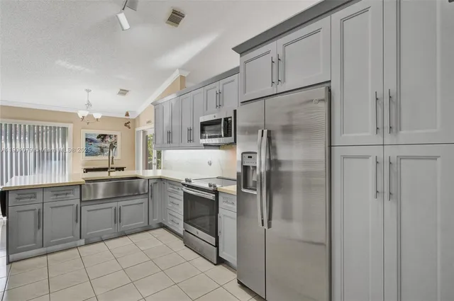 a kitchen with cabinets and stainless steel appliances