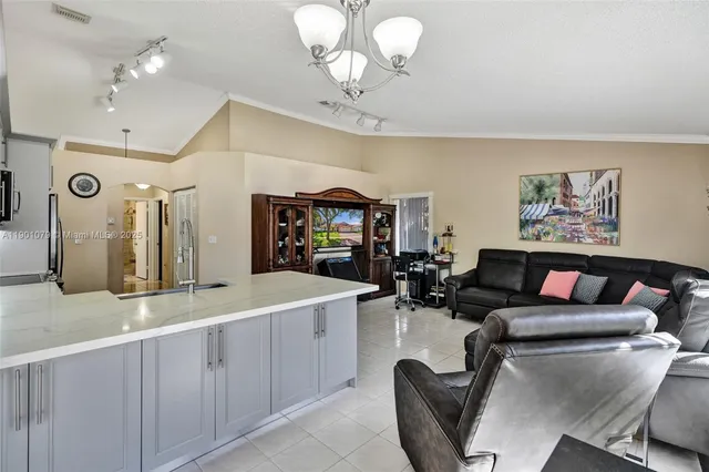 a living room with furniture and a chandelier