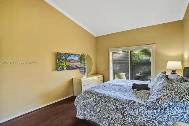 a bed sitting in a bedroom next to a window with lamp