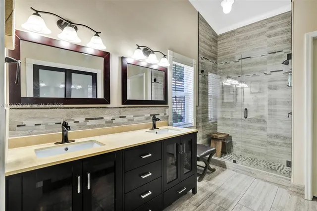 a bathroom with a double vanity sink mirror and double