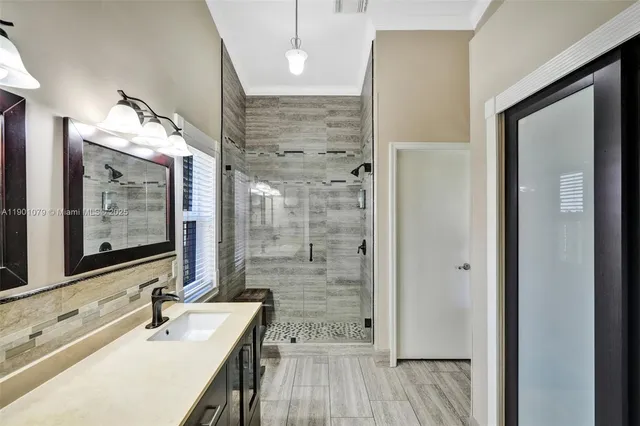 a bathroom with a sink a mirror and shower