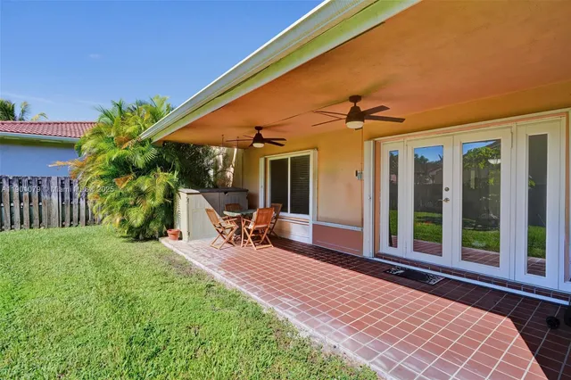 a front view of a house with patio outdoor seating and mountain view in the back