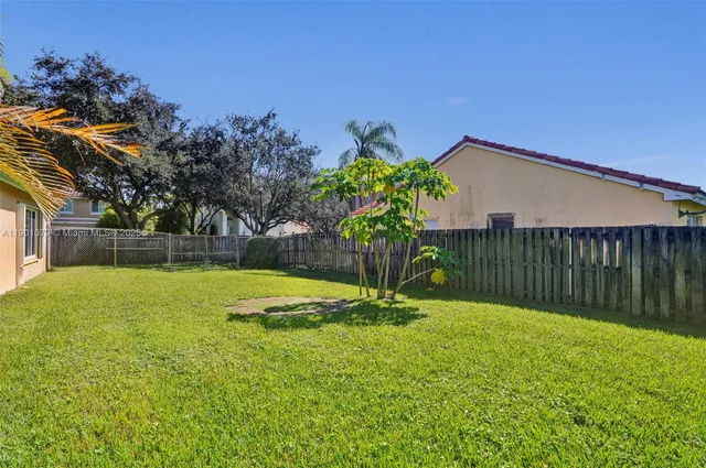 a view of a backyard with a garden and entertaining space