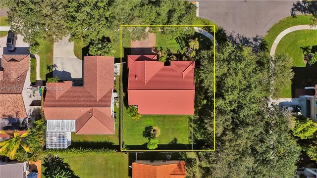 an aerial view of residential houses with outdoor space and swimming pool