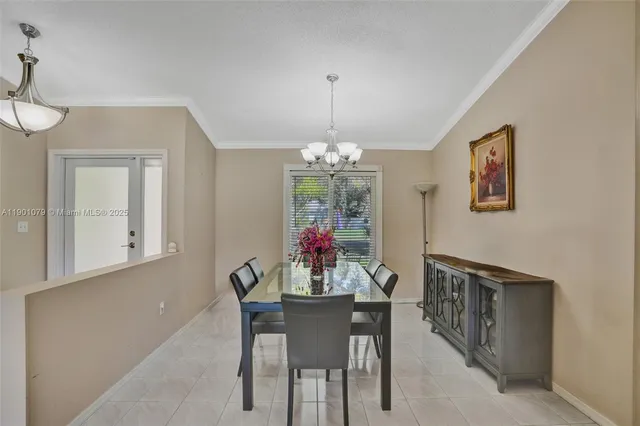 a view of a dining room with furniture wooden floor and chandelier