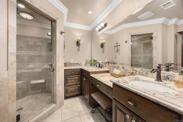 a bathroom with a granite countertop sink a mirror and a shower