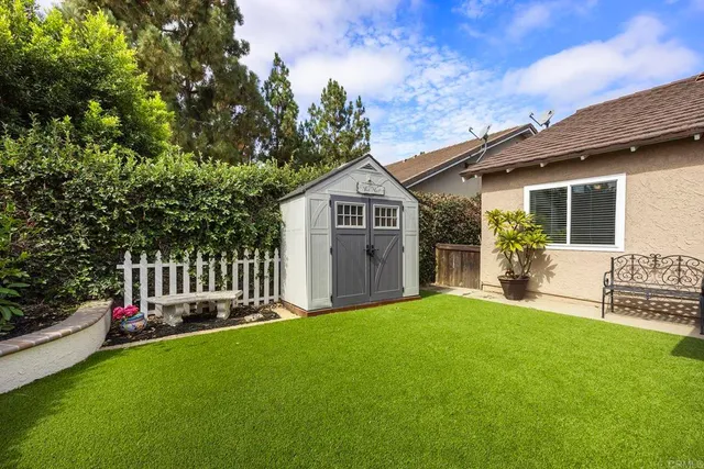 a front view of a house with a garden and yard