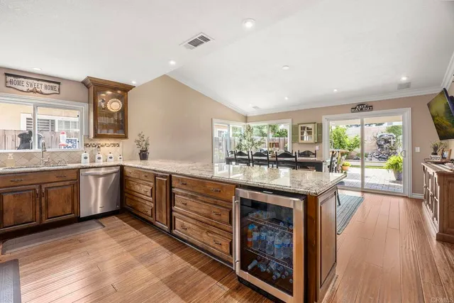 a kitchen with sink stove and wooden floor