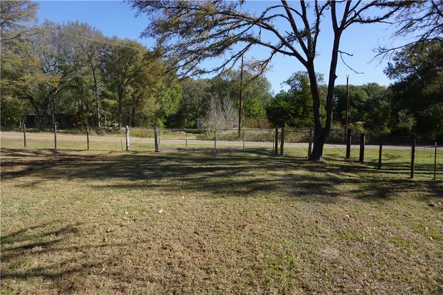 a view of a park with swings and trees