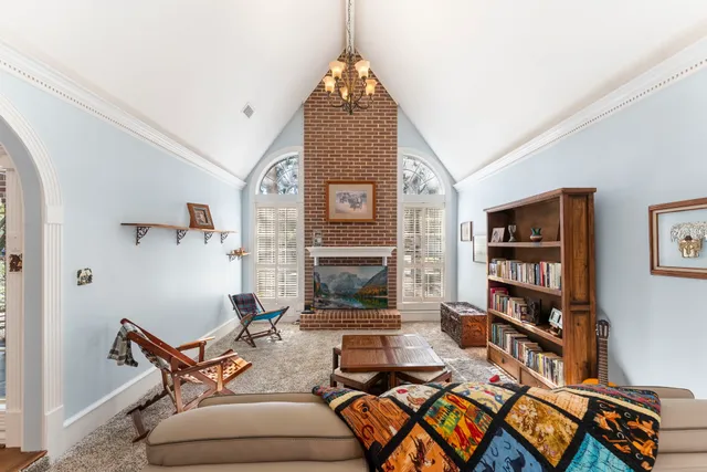 a living room with furniture a air conditioner vent and a window