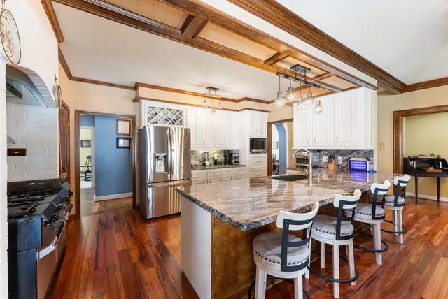 a living room with furniture a ceiling fan and a large window