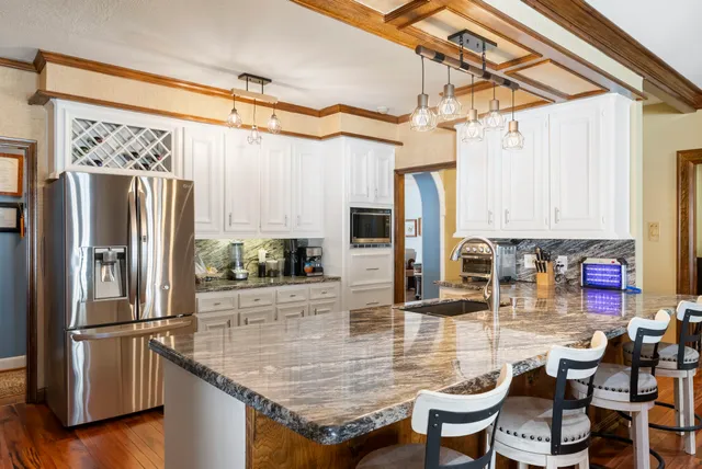 a living room with furniture fireplace and a large window