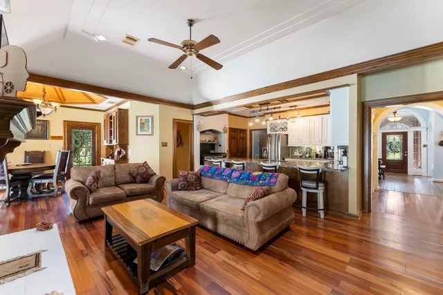 a living room with fireplace furniture and a large window