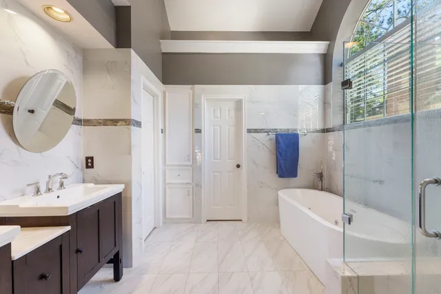 a bathroom with a bathtub and a shower