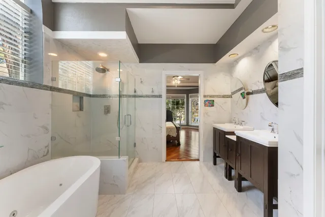 a large bed sitting in a bedroom next to a window