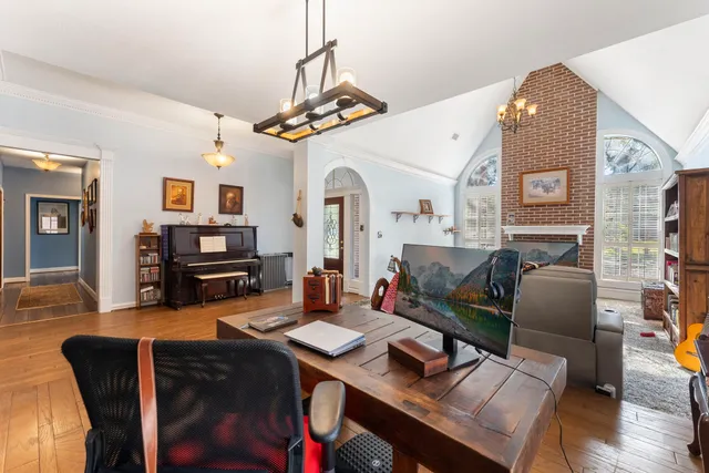 a living room with furniture fireplace and book shelf
