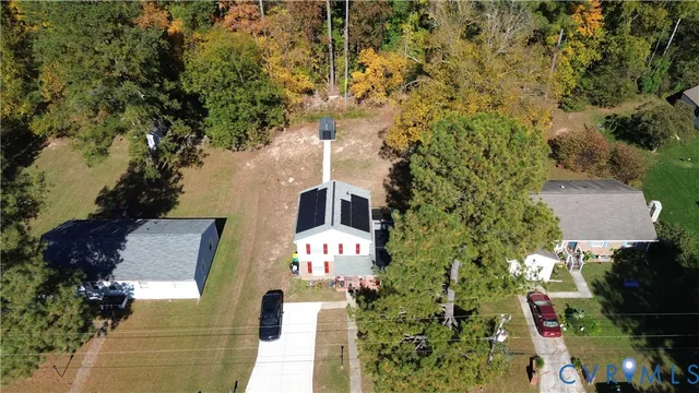 an aerial view of a house with a yard
