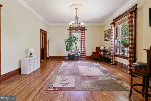 a living room with furniture and a chandelier