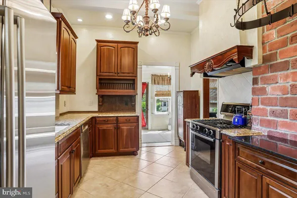 a kitchen with stainless steel appliances granite countertop a stove and a refrigerator
