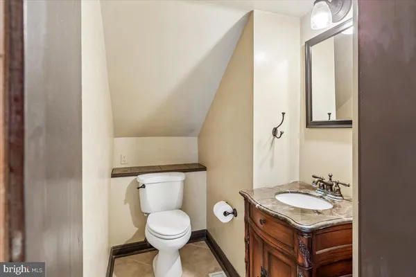 a bathroom with a sink toilet and mirror
