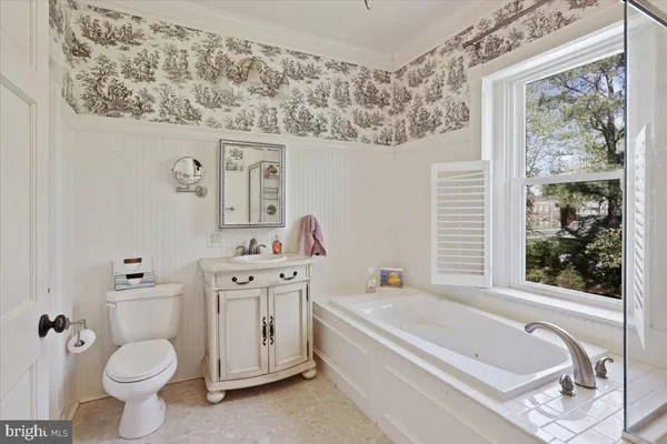 a spacious bathroom with a toilet a sink and a bathtub