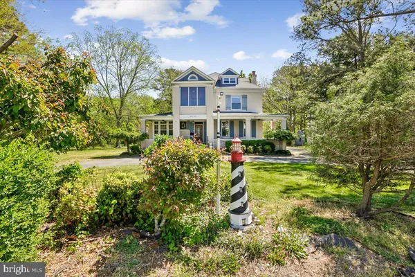 a view of a house with a garden and pathway