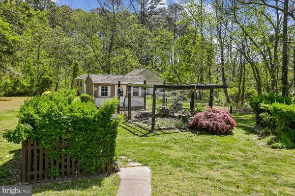 a view of a house with a yard and sitting area