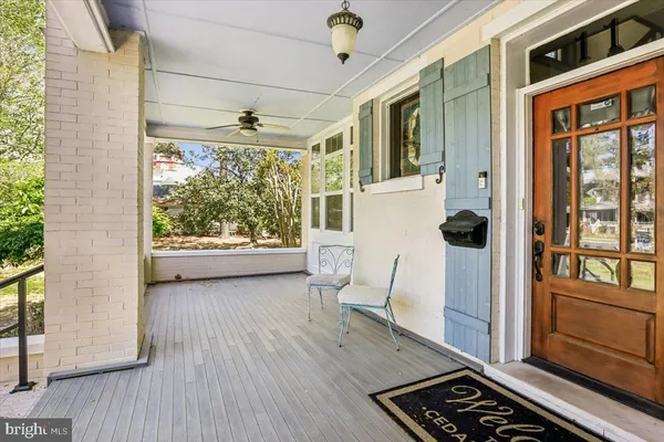 a view of a porch with wooden floor and furniture