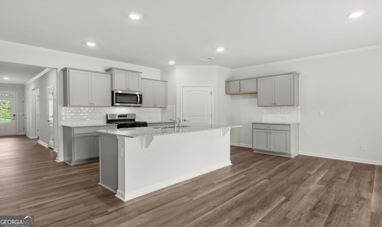 110 Babcock Drive Northeast Rome, GA 30165 - Photo 4 of 12 a kitchen with white cabinets and stainless steel appliances