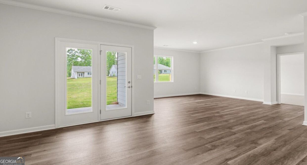 110 Babcock Drive Northeast Rome, GA 30165 - Photo 5 of 12 an empty room with wooden floor and windows