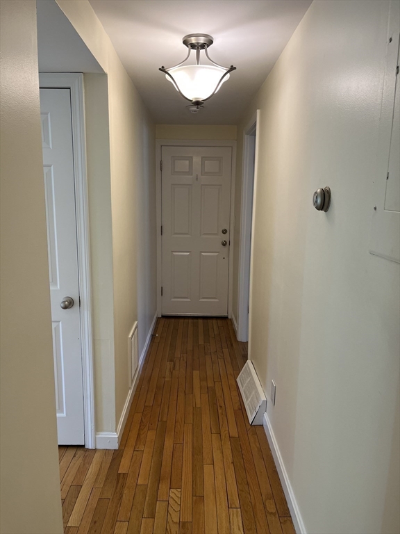 53 Jericho Road, Unit A Weston, MA 02493 - Photo 14 of 16 a view of a room with wooden floor and a ceiling fan