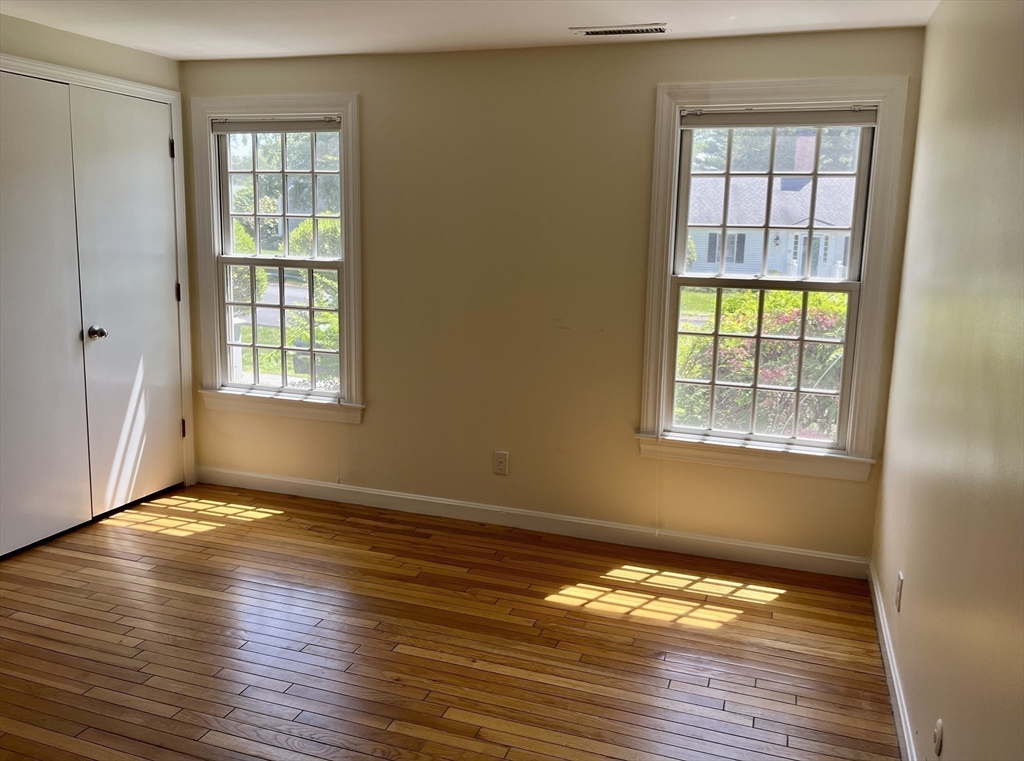 53 Jericho Road, Unit A Weston, MA 02493 - Photo 4 of 16 a view of an empty room with wooden floor and a window