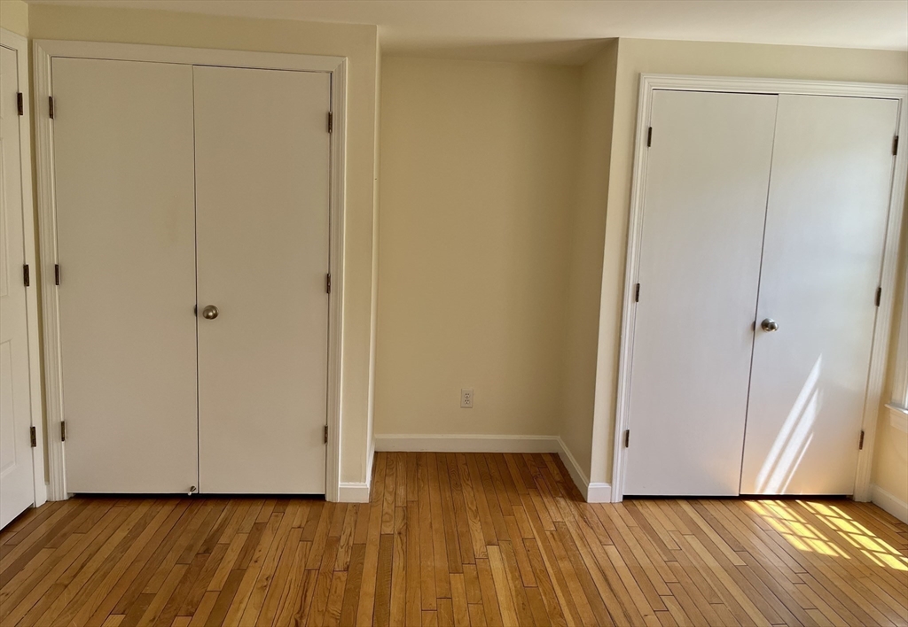 53 Jericho Road, Unit A Weston, MA 02493 - Photo 5 of 16 a view of an empty room and wooden floor