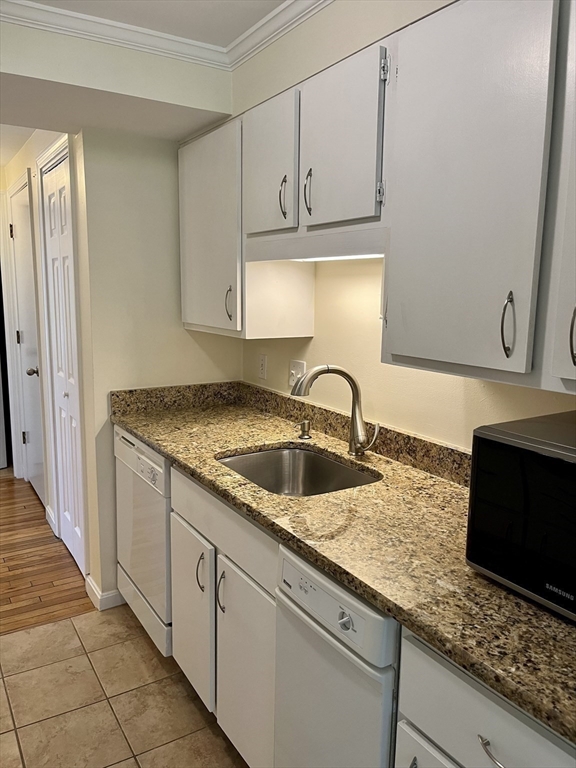 53 Jericho Road, Unit A Weston, MA 02493 - Photo 7 of 16 a kitchen with granite countertop sink stainless steel appliances and cabinets