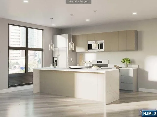 a kitchen with stainless steel appliances granite countertop a sink and cabinets