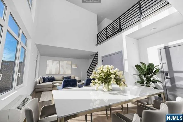 a view of a dining room with furniture and a potted plant