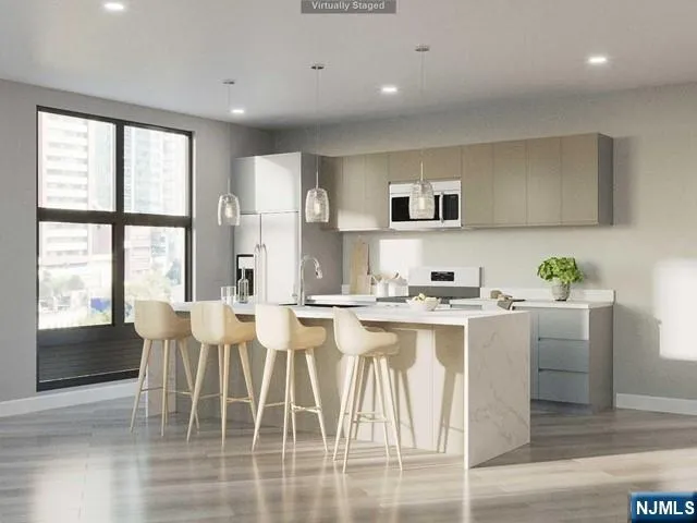 a view of kitchen with cabinets and wooden floor
